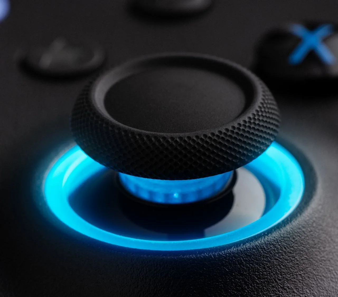 Close-up of a textured thumbstick cap with a lit RGB ring