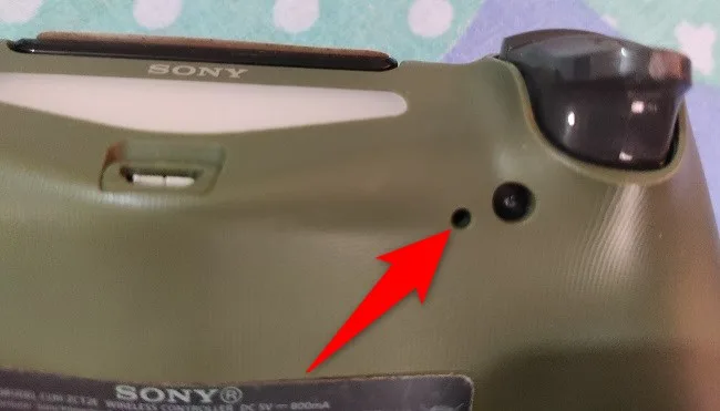 Reset button hole on the back of a DUALSHOCK 4 controller