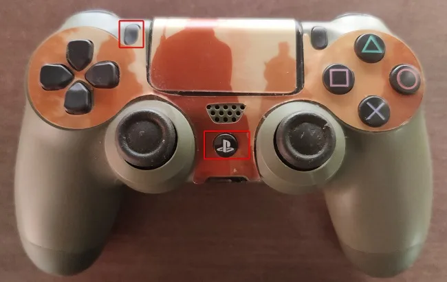 DUALSHOCK 4 controller with the Share button and PS button highlighted for pairing mode
