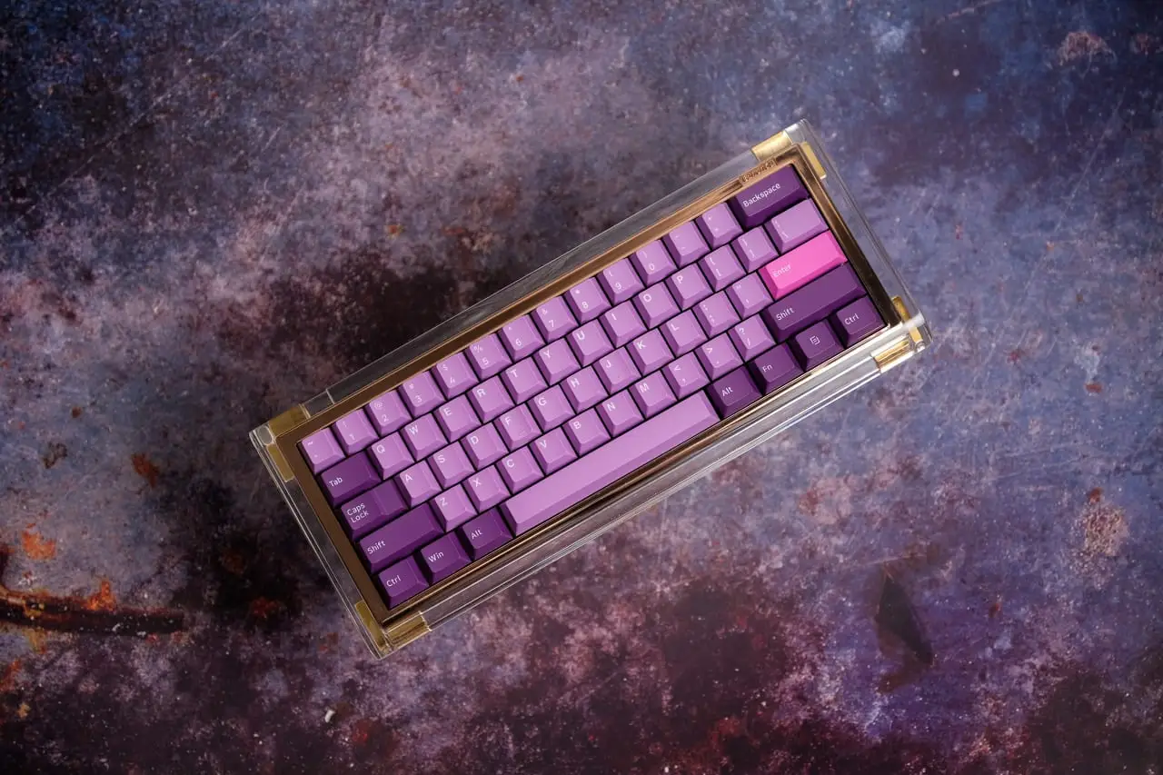 Finished compact custom keyboard with purple PBT keycaps in a clear case