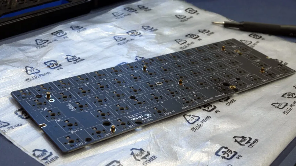 Keyboard PCB laid on a sheet of PE foam before tracing its outline