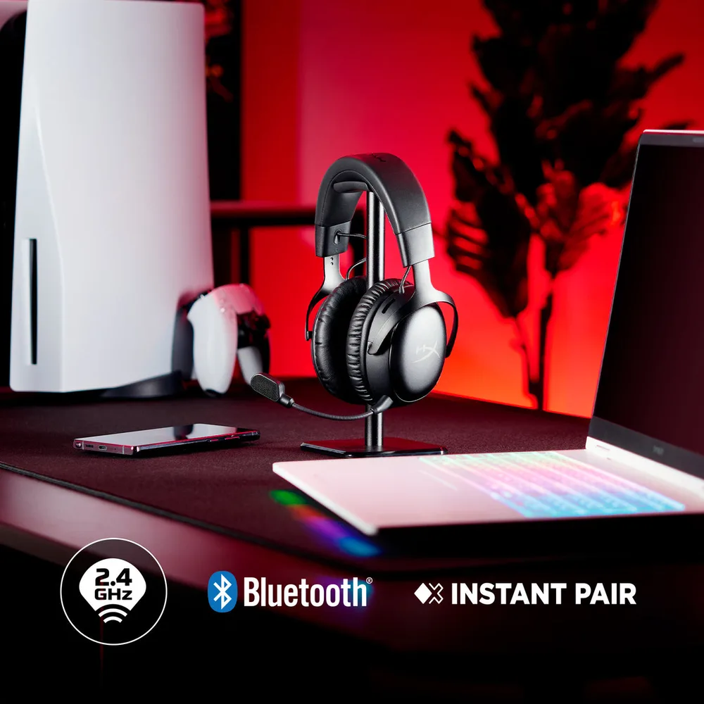 HyperX Cloud III S Wireless on a desk with 2.4GHz, Bluetooth and Instant Pair icons