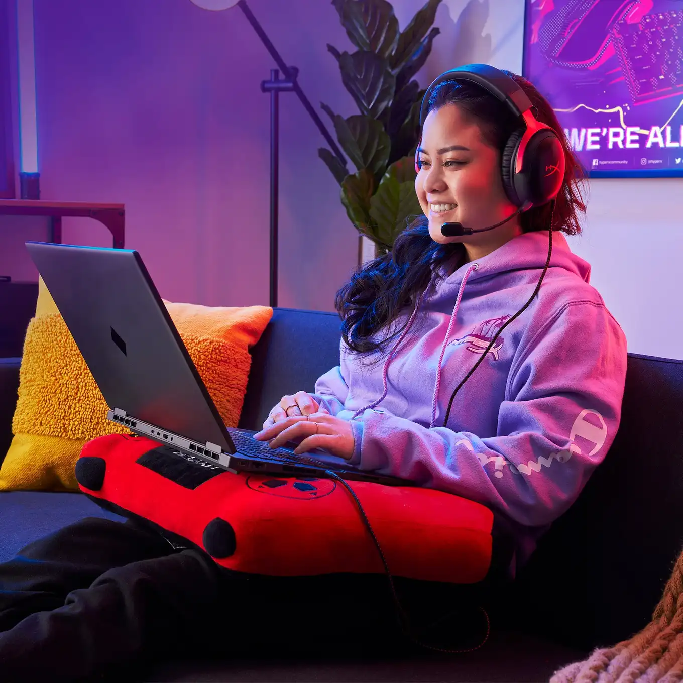 Gamer wearing the HyperX Cloud III with its boom mic while playing on a laptop