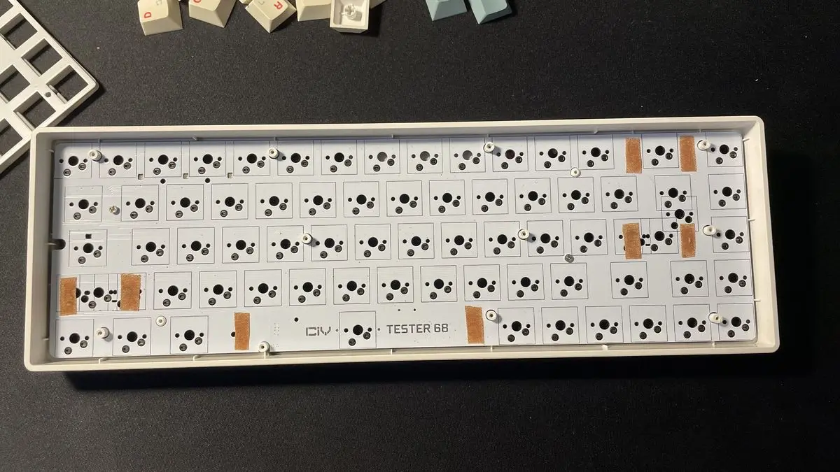 Band-aid strips placed under the stabilizer spots on a keyboard PCB