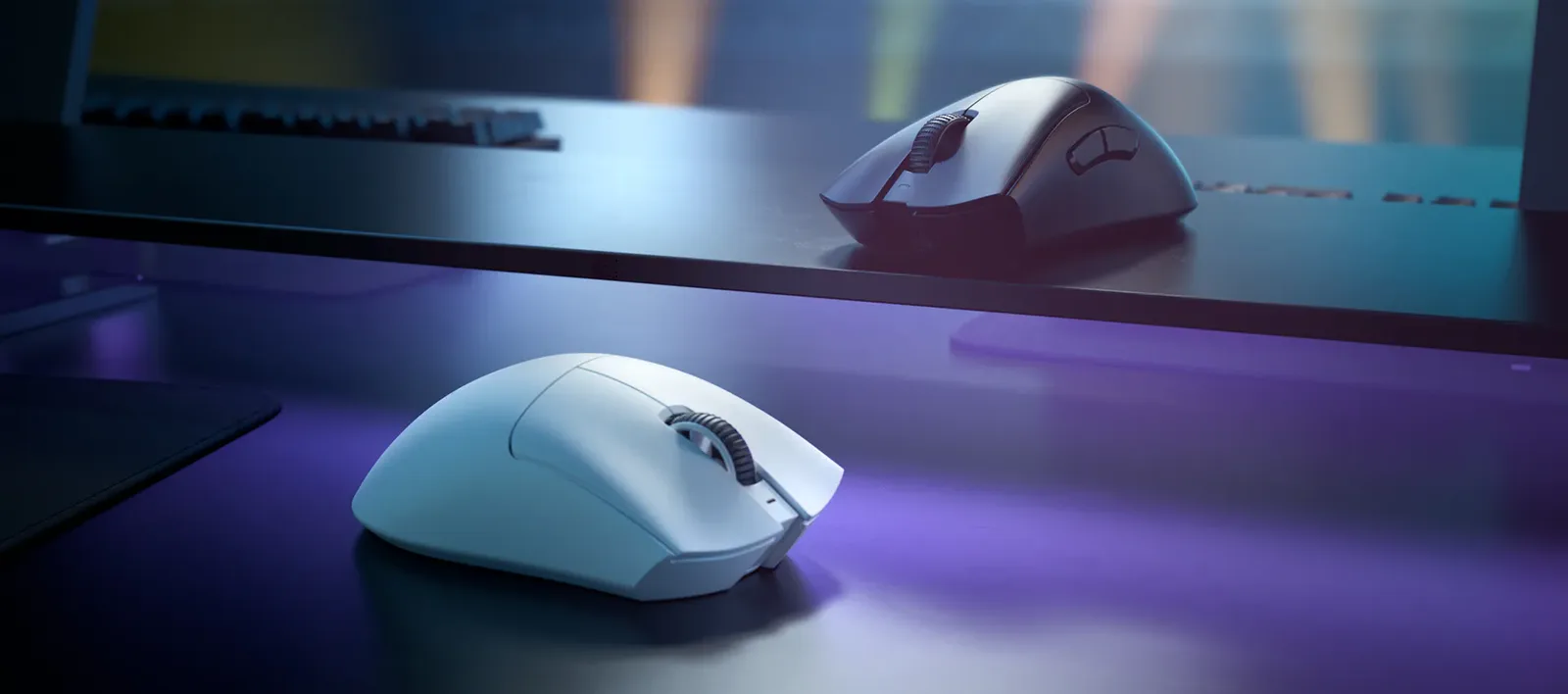 Razer DeathAdder V3 Pro in white and black on a desk, showing the raised ergonomic shell