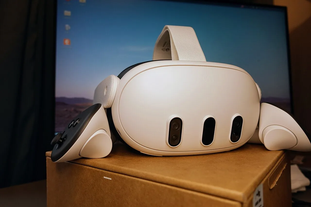 Front view of a Meta Quest 3 headset with its three camera openings and controllers