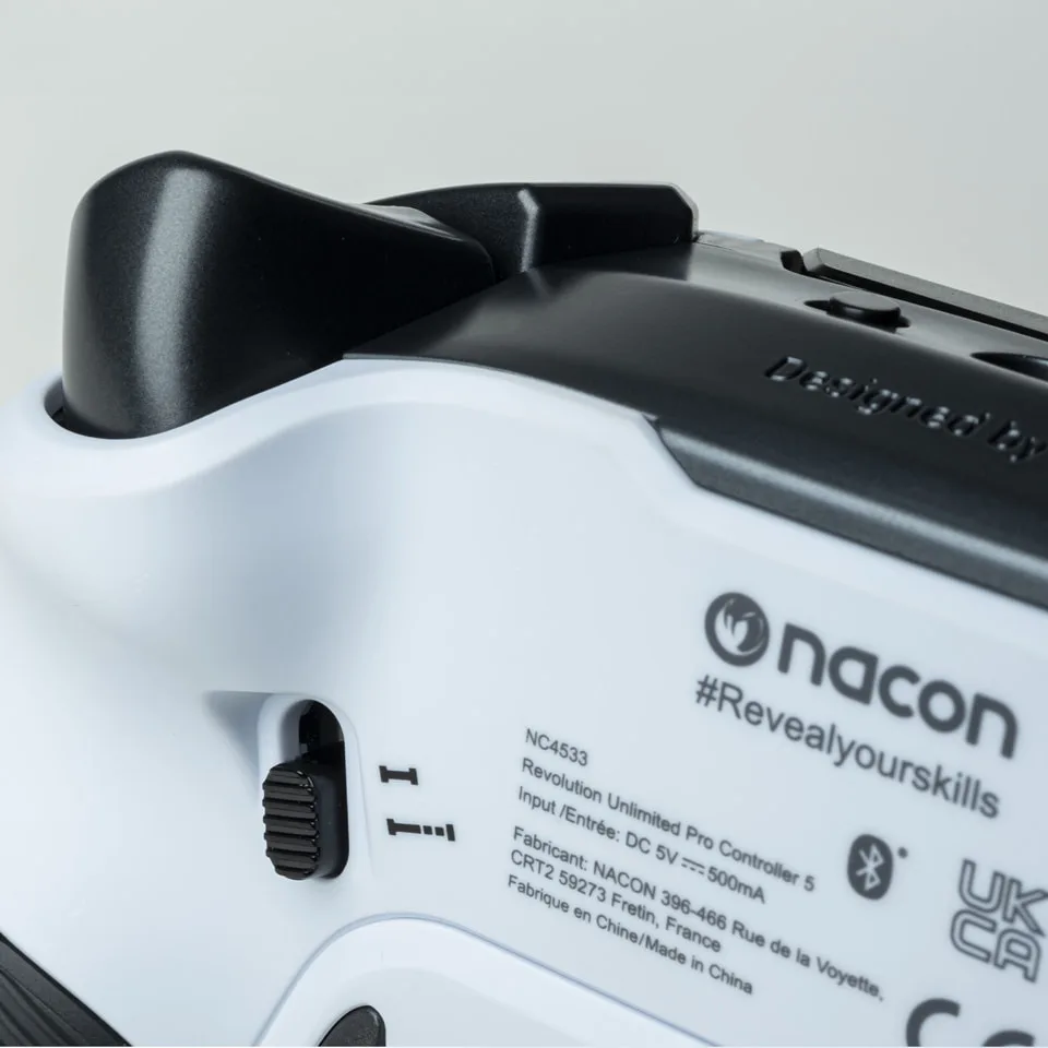 Trigger blocker switch on the back of a white Nacon Revolution 5 Pro
