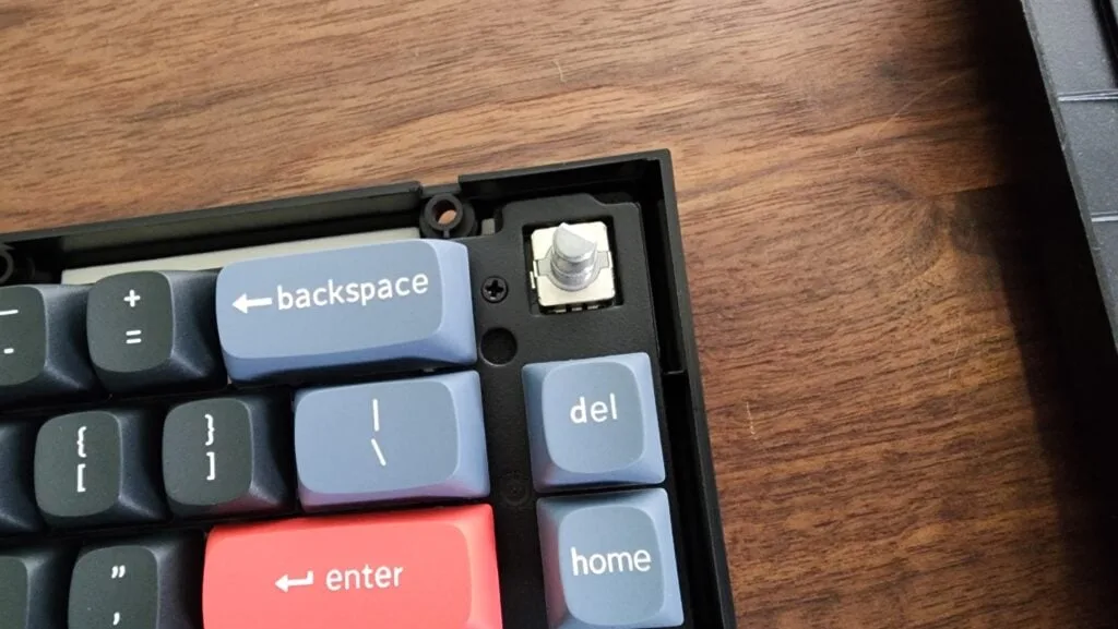 Keyboard plate and keycaps being refitted into the case after a tape mod