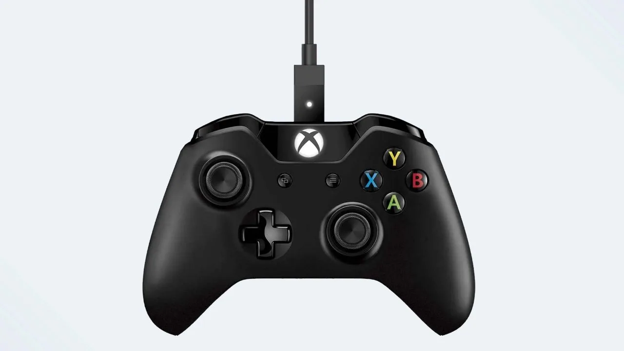 Xbox controller with a USB cable plugged into the port on its top edge
