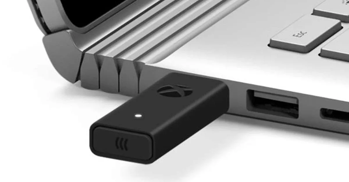 Xbox Wireless Adapter plugged into a USB port on the side of a laptop